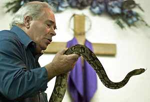Pastor Hal W. Hubbard caresses an Eastern Diamondback rattlesnake.