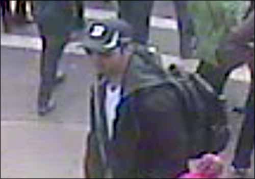 The black-capped suspect disguised himself with sunglasses.